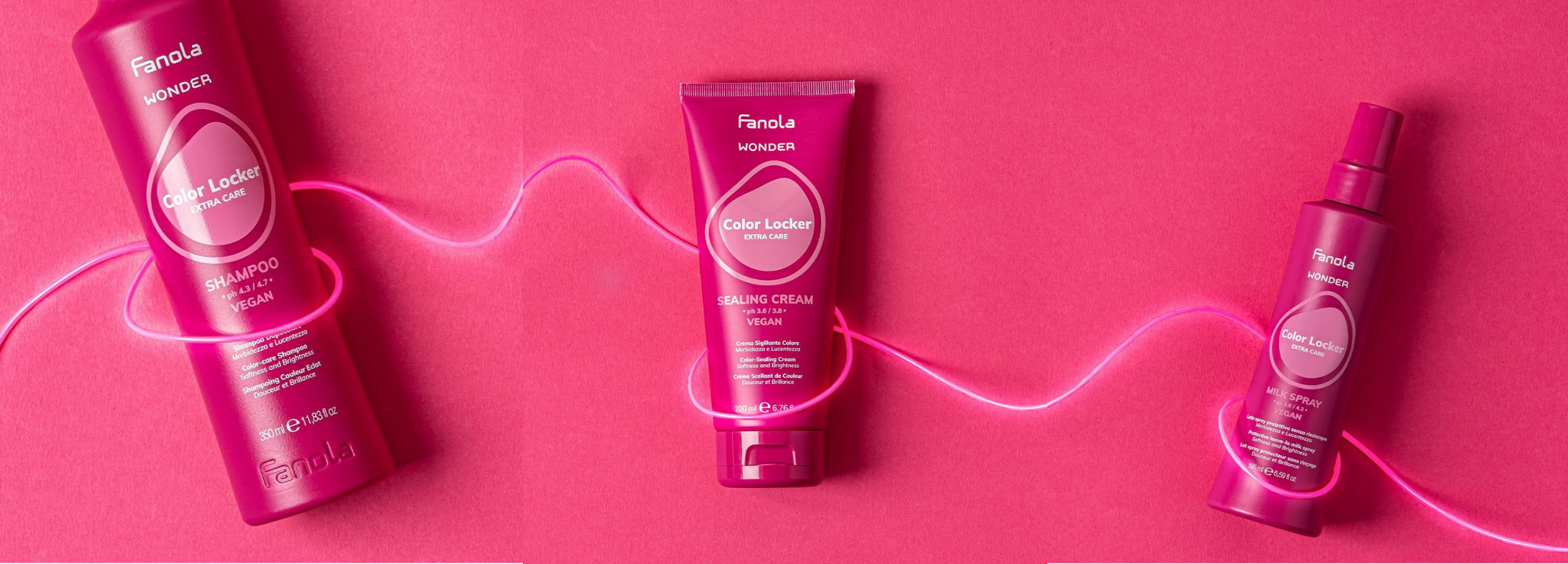 Fanola Wonder Color Locker hair care set: shampoo, sealing cream, milk spray on pink background