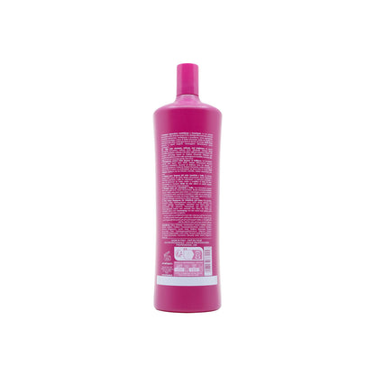 Pink bottle of sulfate-free after-color shampoo for softness and shine, made in Italy