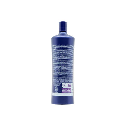 Blue professional hair care bottle with multilingual instructions, made in Italy for salon use
